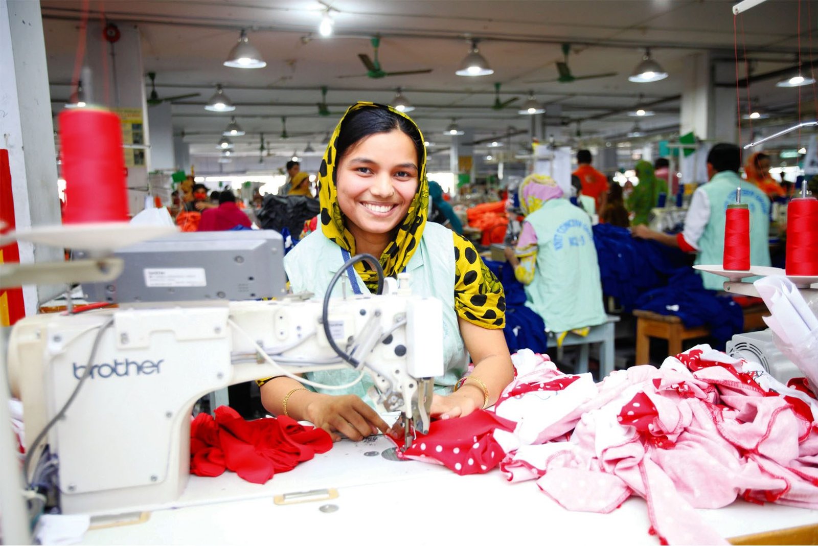 Sewing machine operator working on a garment production line at a partner factory in Bangladesh